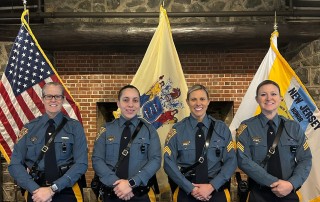 17 NJ State Troopers in dress uniform with flags