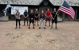 Lady Blue & Gold members with the American flag